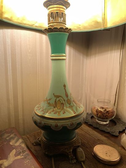 A polychrome enameled porcelain oil lamp...
