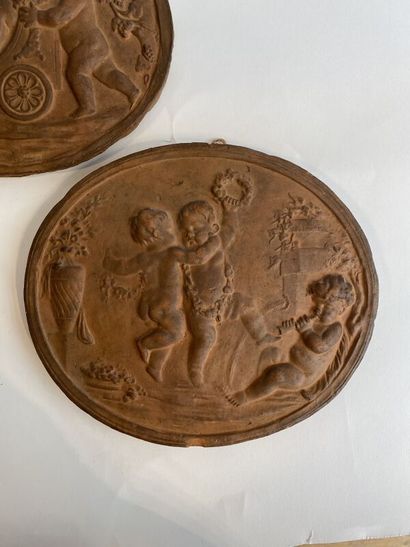 Six terracotta medallions with stamped putti...