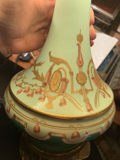 A polychrome enameled porcelain oil lamp...