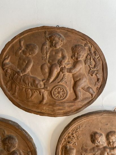 Six terracotta medallions with stamped putti...