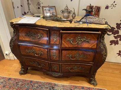 A veneered chest of drawers opening to four...