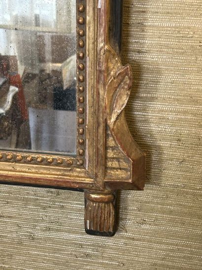 Gilded wood mirror with pearl frieze, 
stylized...