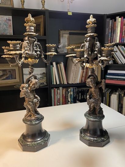 Pair of candelabras with cherubs holding...
