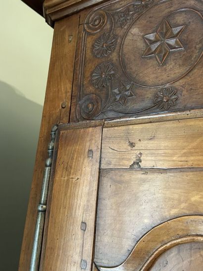 Walnut cabinet, molded and carved with flowers,...