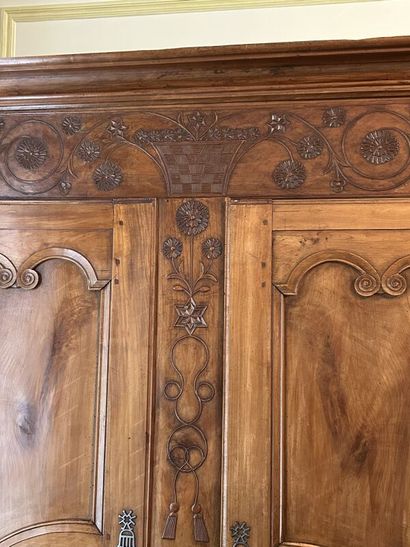 Walnut cabinet, molded and carved with flowers,...