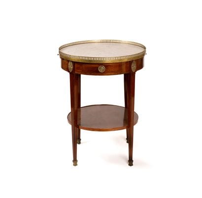 Circular mahogany-veneered coffee table with...