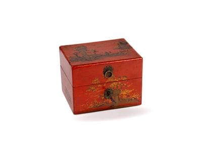 A red-and-gold lacquered wooden perfume set...