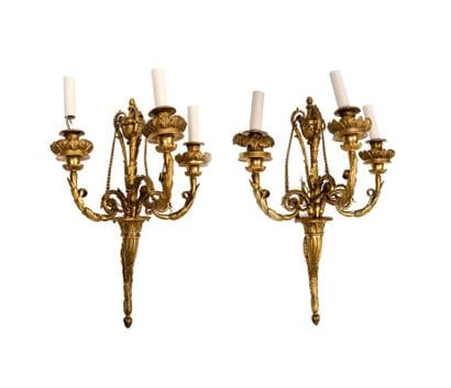 A pair of imposing chiseled and gilded bronze...