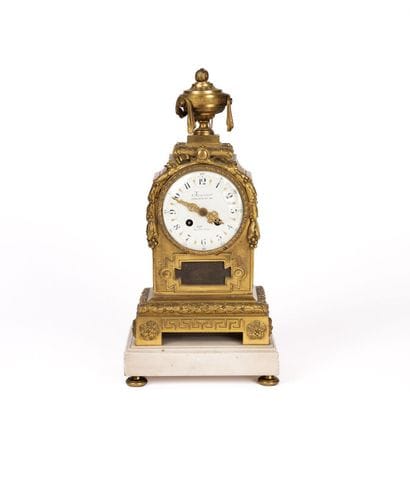 A bronze clock with a chiseled and gilded...