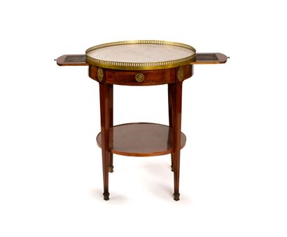 Circular mahogany-veneered coffee table with...