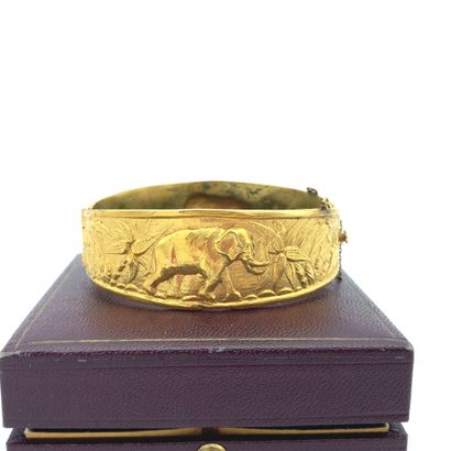 BRACELET in gilded metal with embossed decoration...