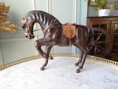 Paper maché and leather-covered horse. (...