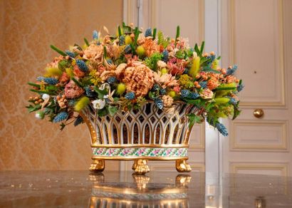 Openwork porcelain planter resting on four...
