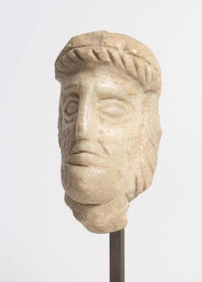Carved stone man's head.

Gallo-Roman style...