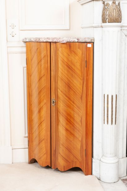 
A pair of rosewood veneered corner cabinets...