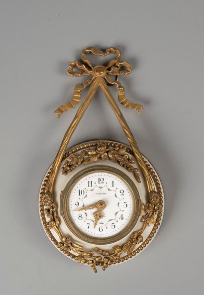 Wall clock in marble and chased and gilded...