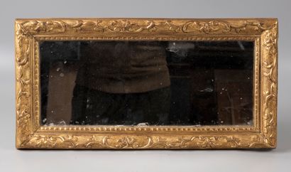 Miniature mirror in carved and gilded wood.

Louis...