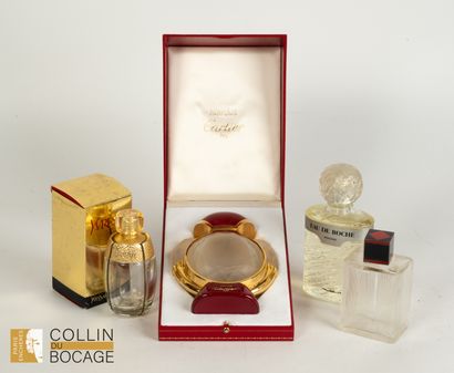 Set of four perfume bottles including Cartier,...