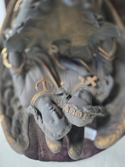 Cast-iron holy water font with two angels....