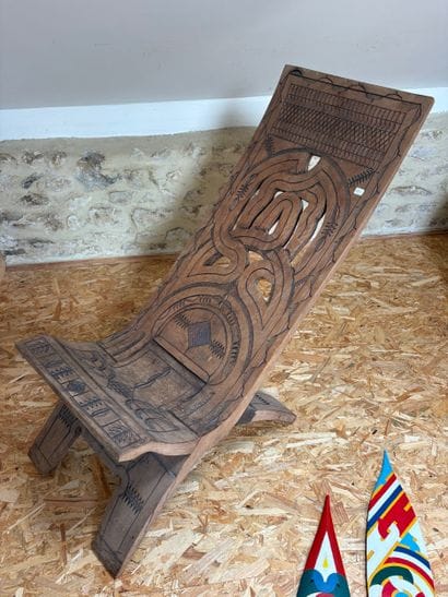 An openwork folding chair decorated with...