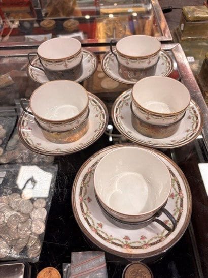Four porcelain cups and saucers. Silver rims....