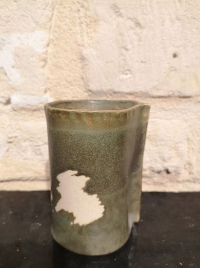 Olive-green ceramic vase with a reserve-decorated...