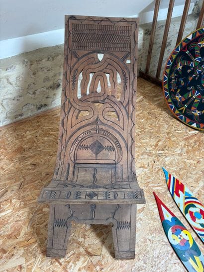 An openwork folding chair decorated with...