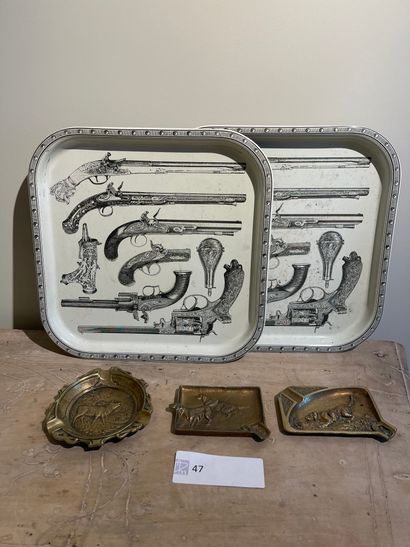Two trays in sheet metal decorated with weapons,...