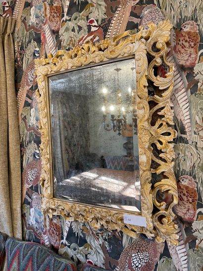 Wood and stucco mirror decorated with openwork...