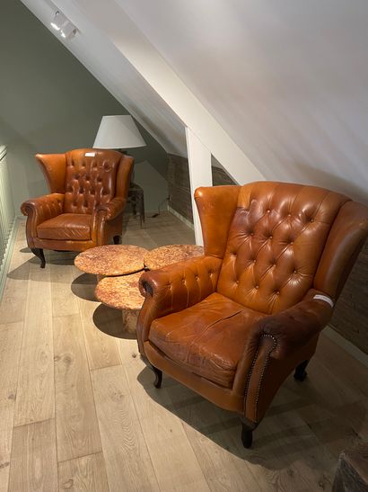 Pair of tan leather armchairs with ears and...