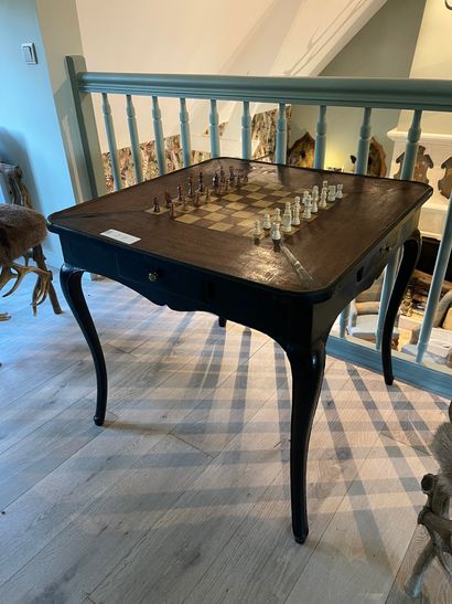 Black patinated wood game table opening with...