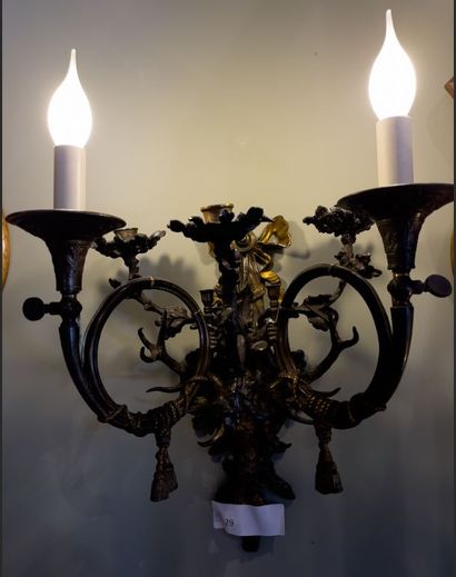 A pair of ormolu sconces decorated with a...