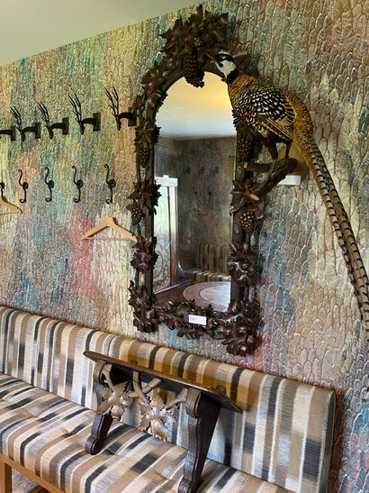 A large carved wood mirror decorated with...