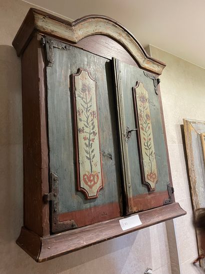 Small cabinet with painted decoration opening...