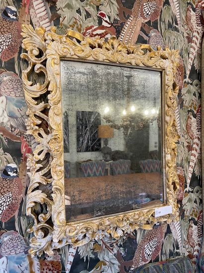 Wood and stucco mirror decorated with openwork...