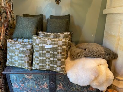 Three white and two green-grey fur skins...
