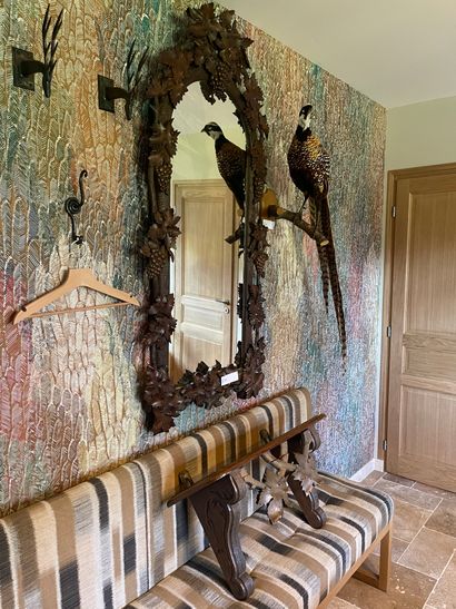 A large carved wood mirror decorated with...