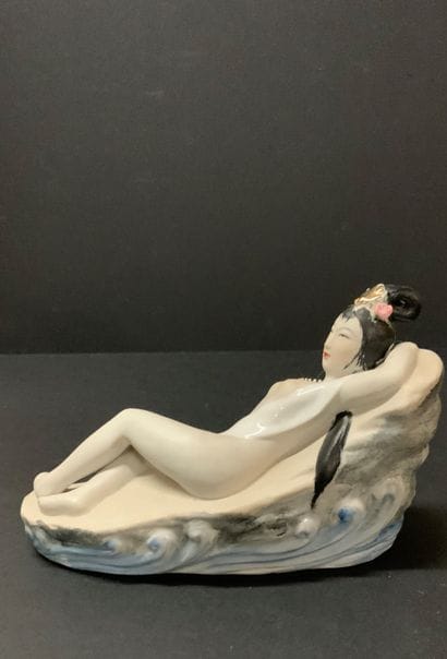 Polychrome porcelain group featuring a bedraggled...