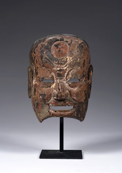 Nuo theater mask depicting
a smiling Buddhist...