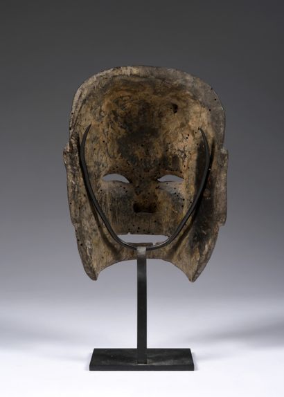 Nuo theater mask depicting
a smiling Buddhist...