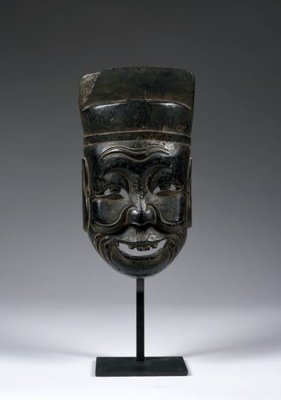 Nuo theater mask depicting Tudigong the
god...