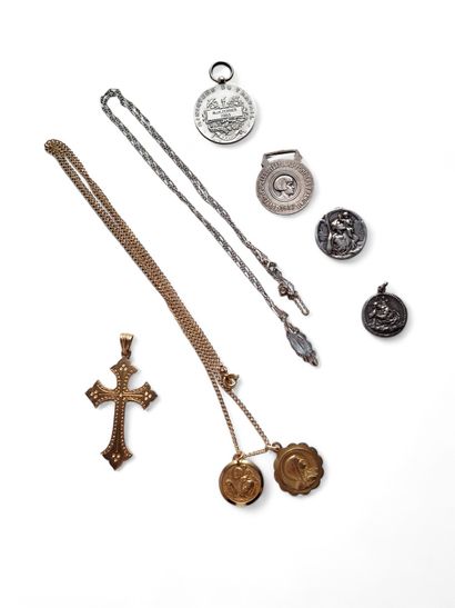 A gold chain and pendant decorated with a...
