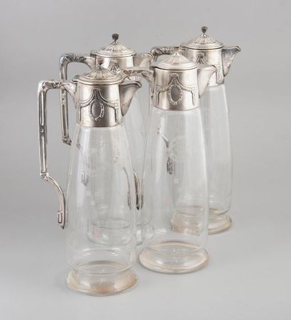 Quatre aiguières en verre taillé et monture...