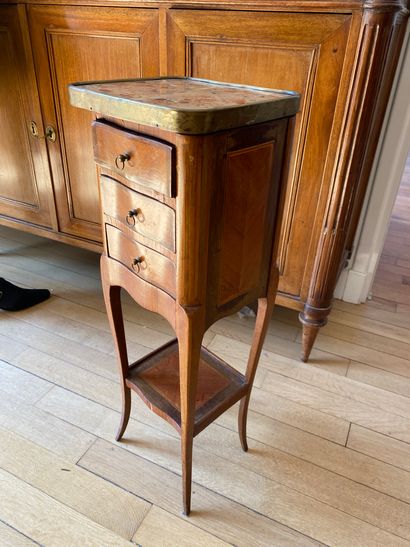 Small veneered bedside table opening to three...