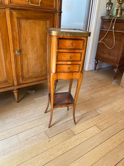 Small veneered bedside table opening to three...