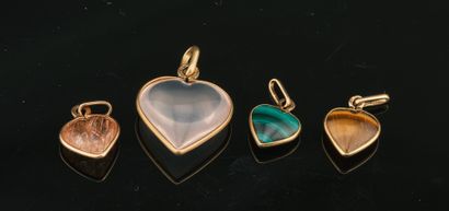 Four small charms in gold, moonstone, tiger's...