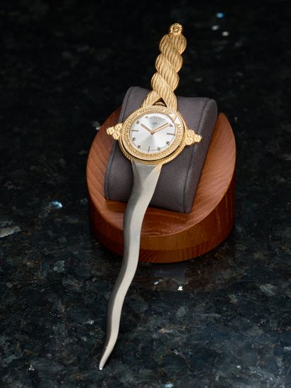 Gilded metal letter opener centered on a...