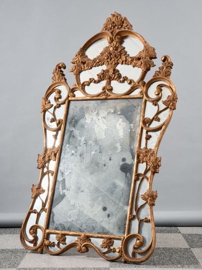 Carved and gilded wood mirror with rich scroll...