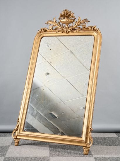 Large mirror in carved and gilded wood, the...