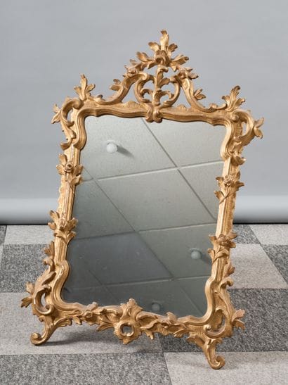 Carved and gilded wood mirror decorated with...